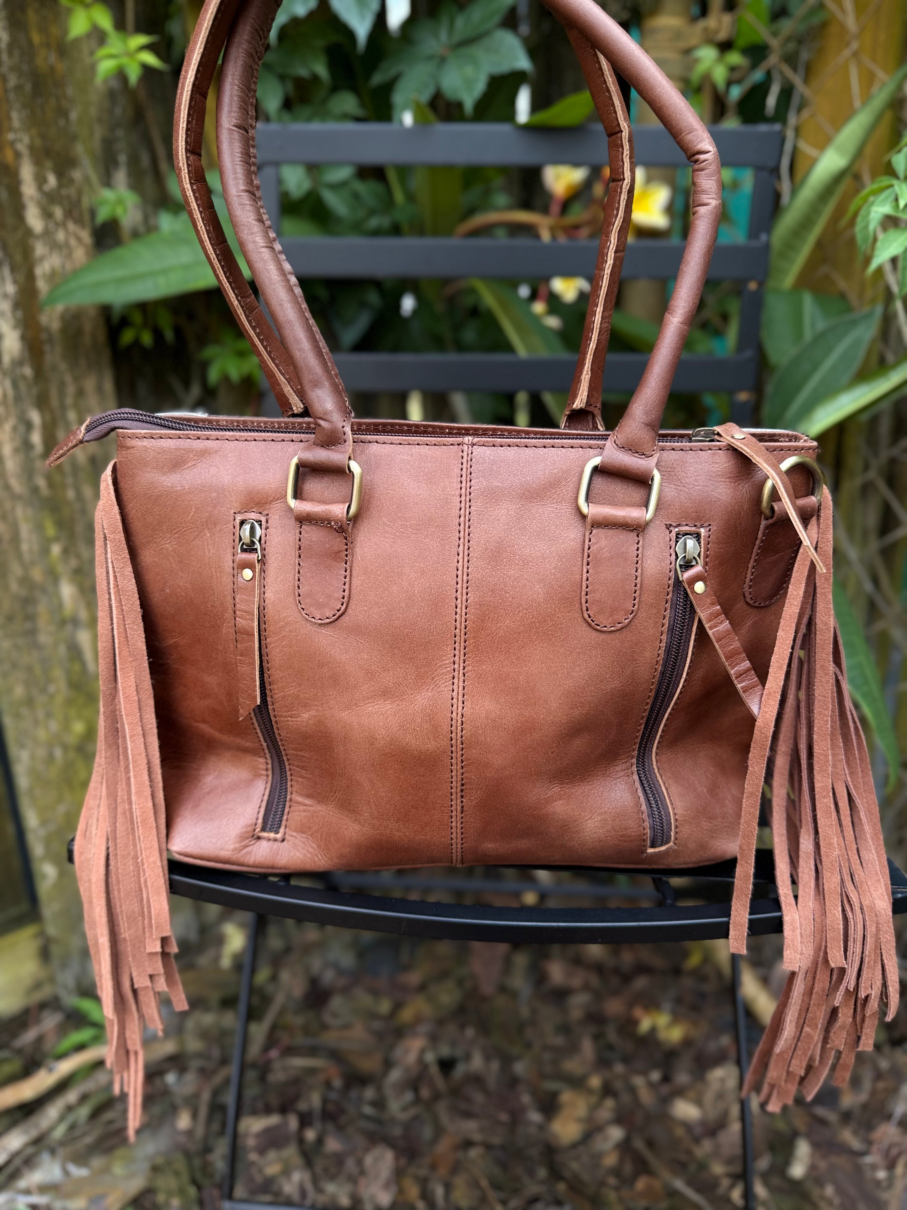 The Frontier Fringe Carryall | Cowhide, tooling, fringe, and function. Includes concealed carry pocket and two ways to wear