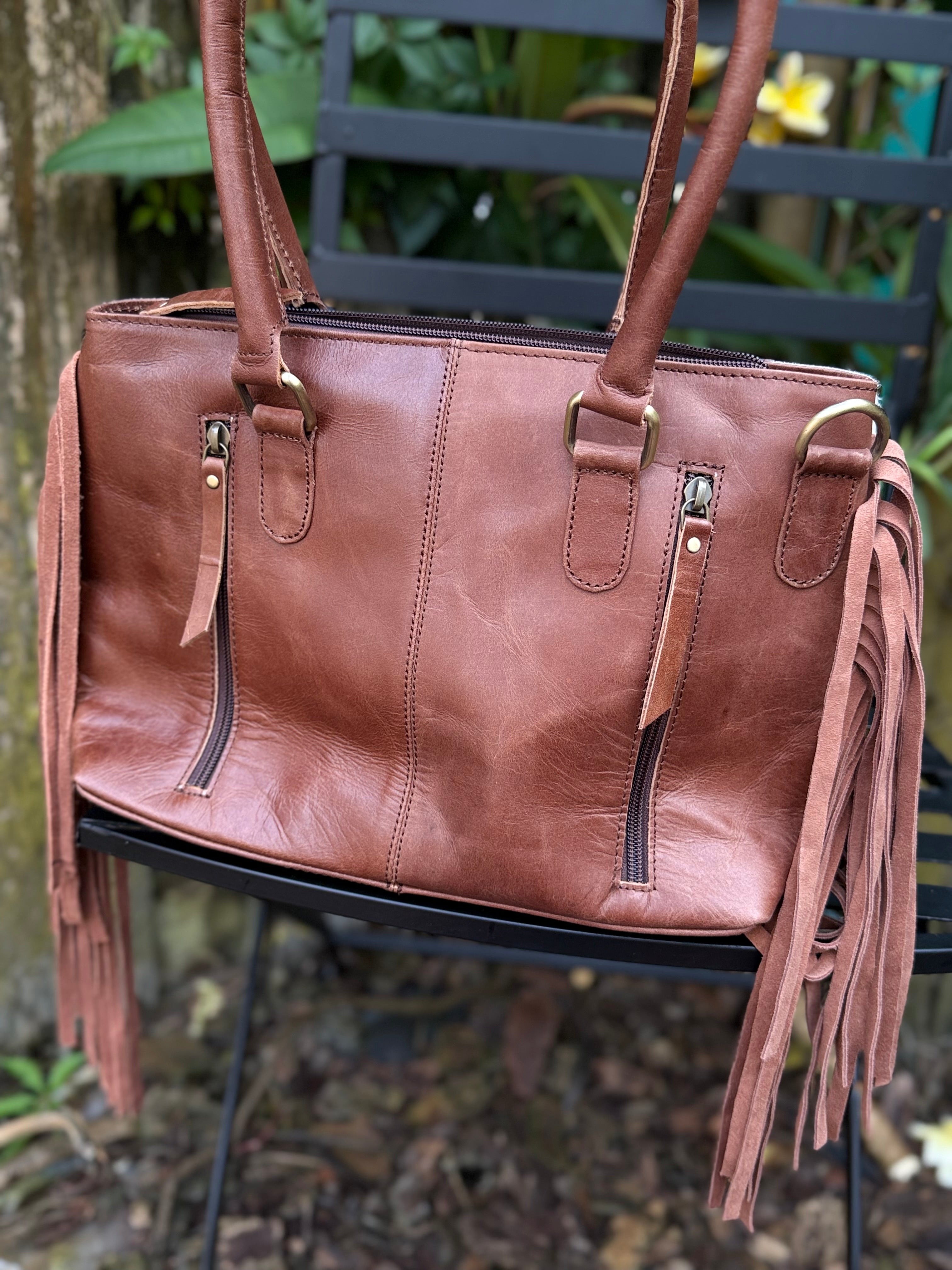 The Frontier Fringe Carryall | Cowhide, tooling, fringe, and function. Includes concealed carry pocket and two ways to wear