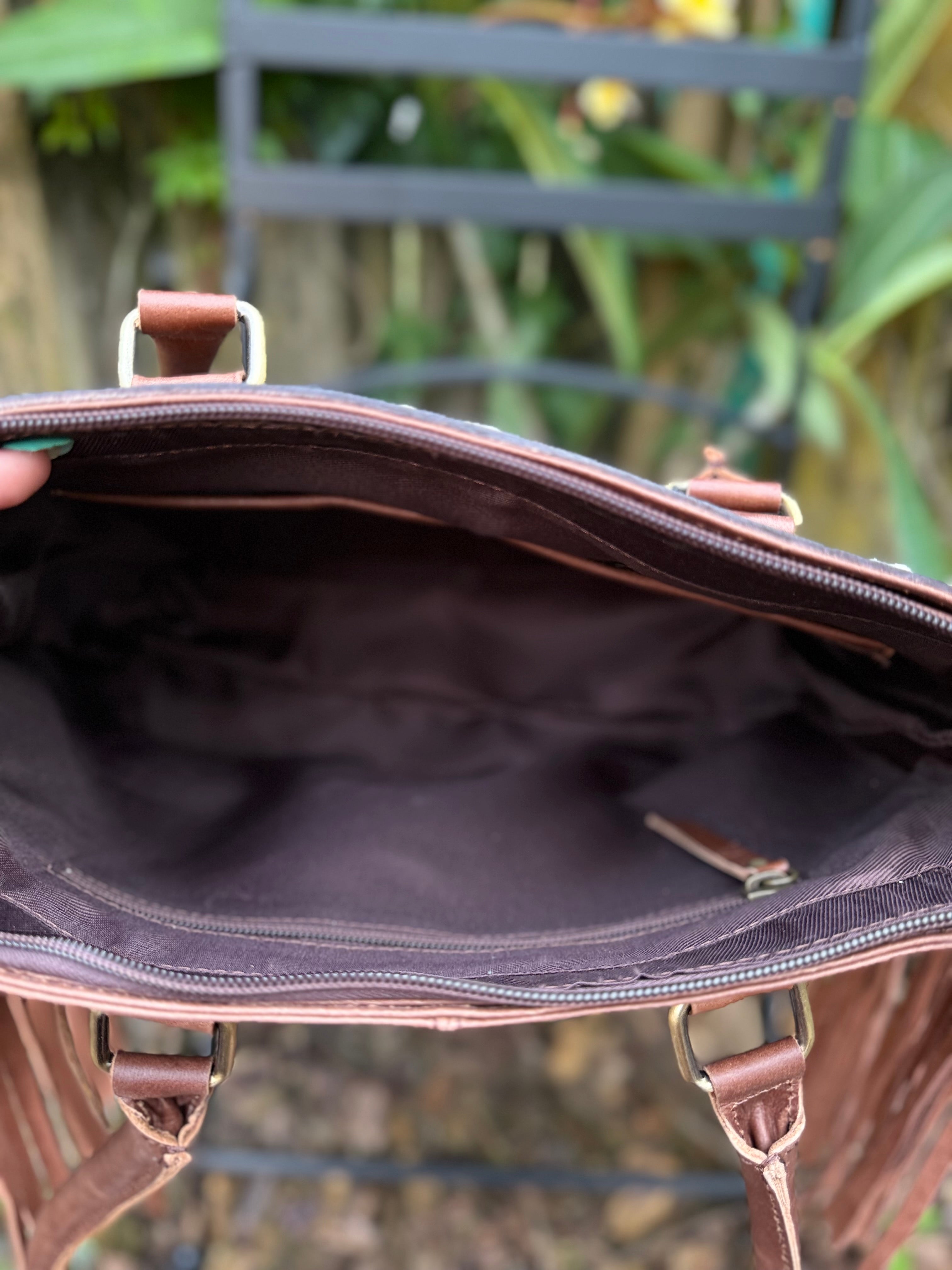 The Frontier Fringe Carryall | Cowhide, tooling, fringe, and function. Includes concealed carry pocket and two ways to wear